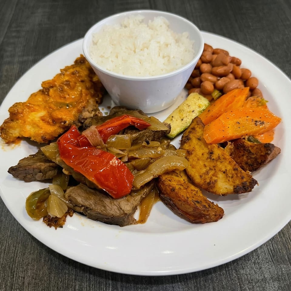 A white plate with steak and peppers, rice, beans, roasted potatoes, and carrots.